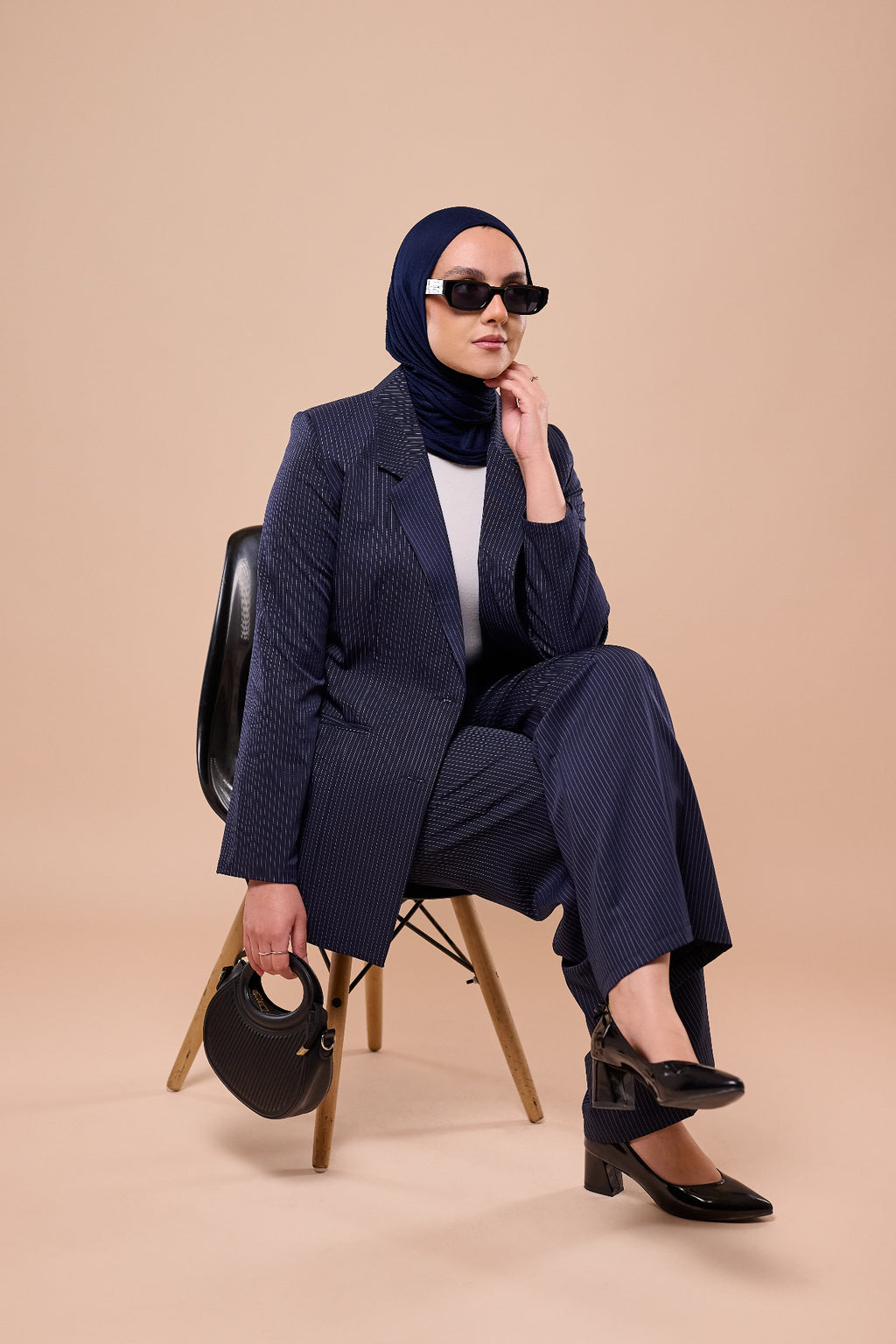 Pinstripe Suit in Navy - full length seated